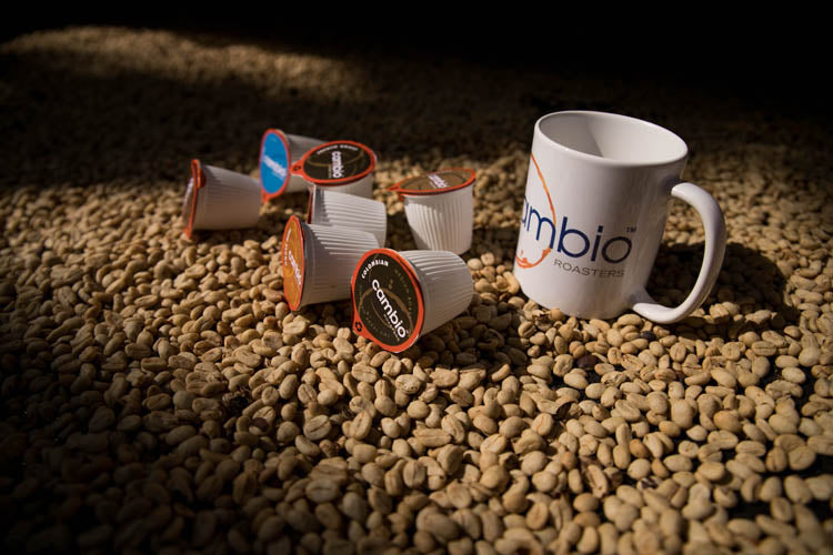a professional image of coffee beans with cambio coffee pods on it