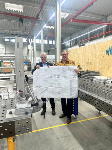 people holding up a plan