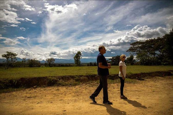 owners of cambio standing on a dirt road
