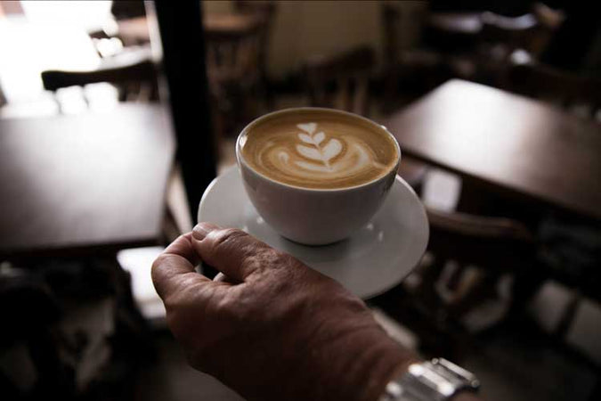 a freshly brewed coffee cup with cream picture in it