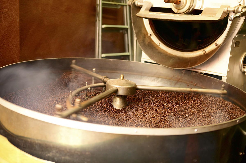a bunch of coffee being roasted in a coffee roaster
