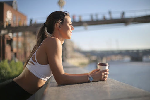 lady drinking coffee on a dock