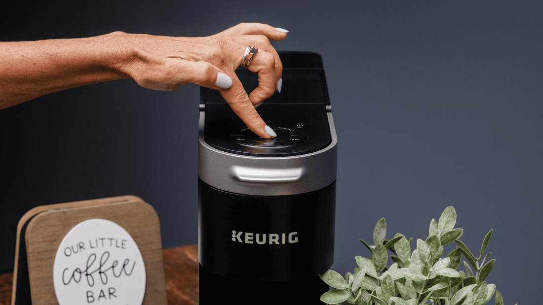 Person pushing a coffee pod machine down to make coffee