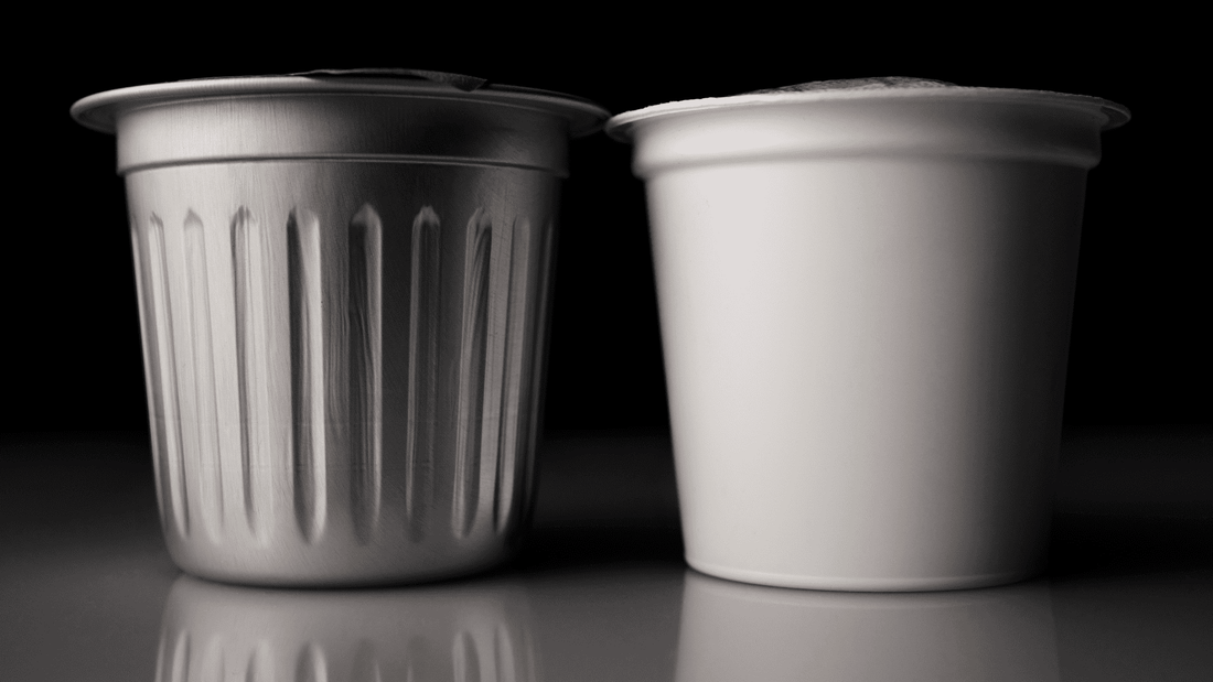 A cambio coffee pod next to a plastic coffee pod