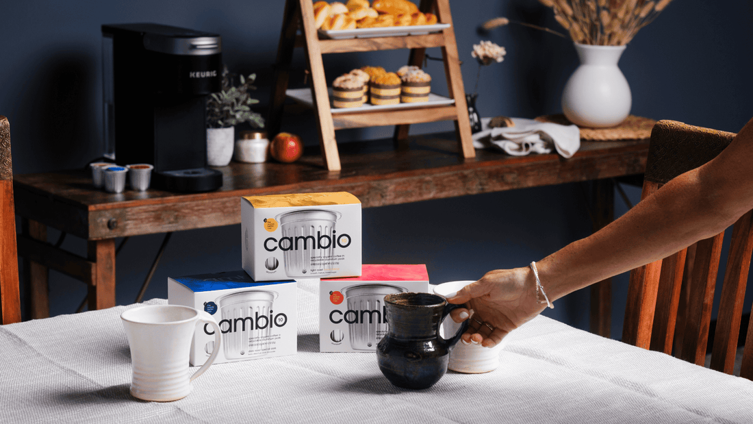 Cambio boxes with a person putting a coffee mug down