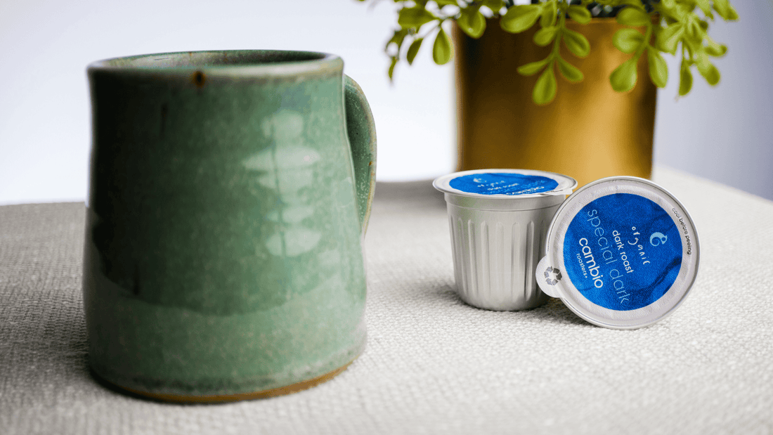 a coffee mug with cambio aluminum coffee pods next to it