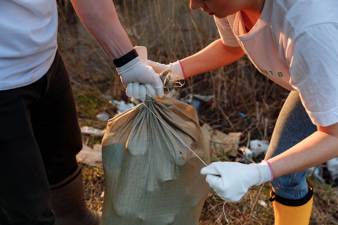 people getting bags of trash for the environment