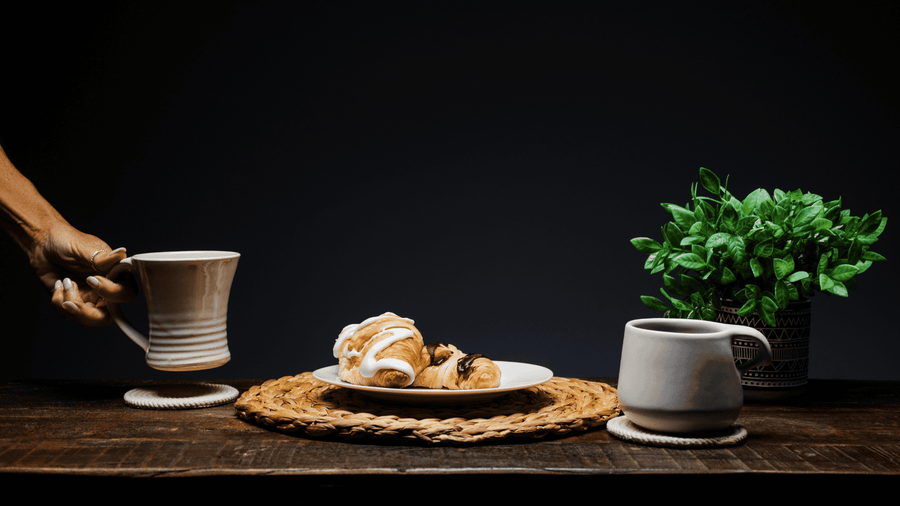 a table with some bread and coffee on it