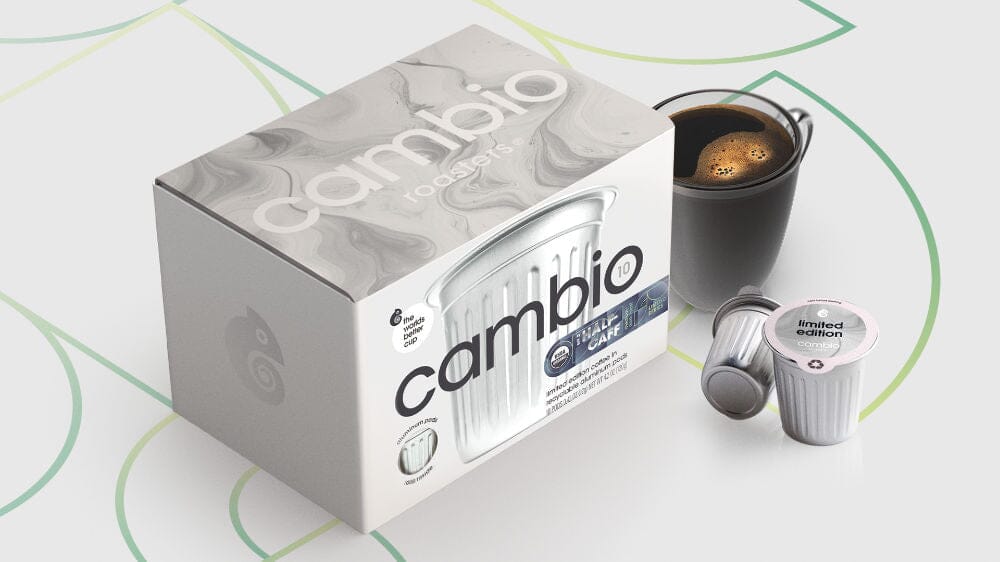 Box of Cambio coffee pods with a coffee pod and coffee cup on a light background