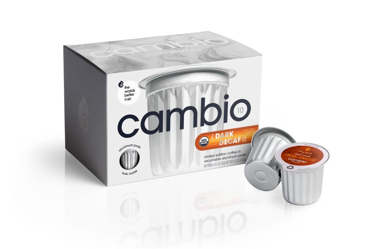A 10 count box of Cambio Dark Decaf coffee pods with two individual silver coffee pods displayed in front on a clean white background.