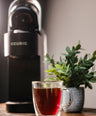 a keurig with a mug of coffee in front of it