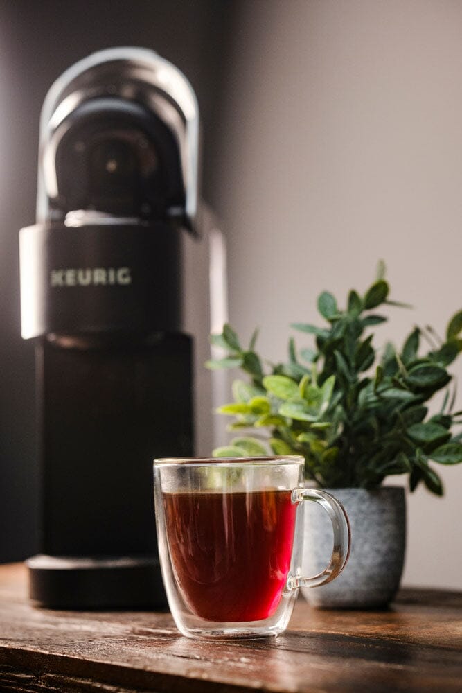 a keurig with a mug of coffee in front of it