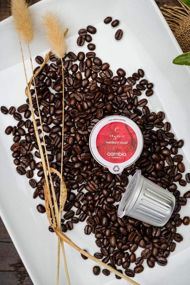 cambio coffee pods on a plate with coffee beans