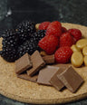 a platter of fruits and chocolate