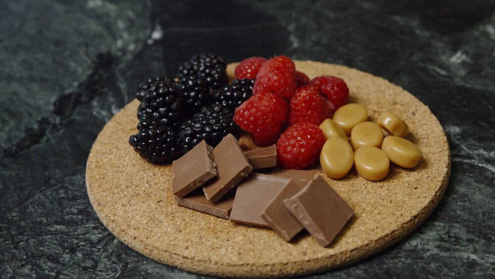 a platter of fruits and chocolate